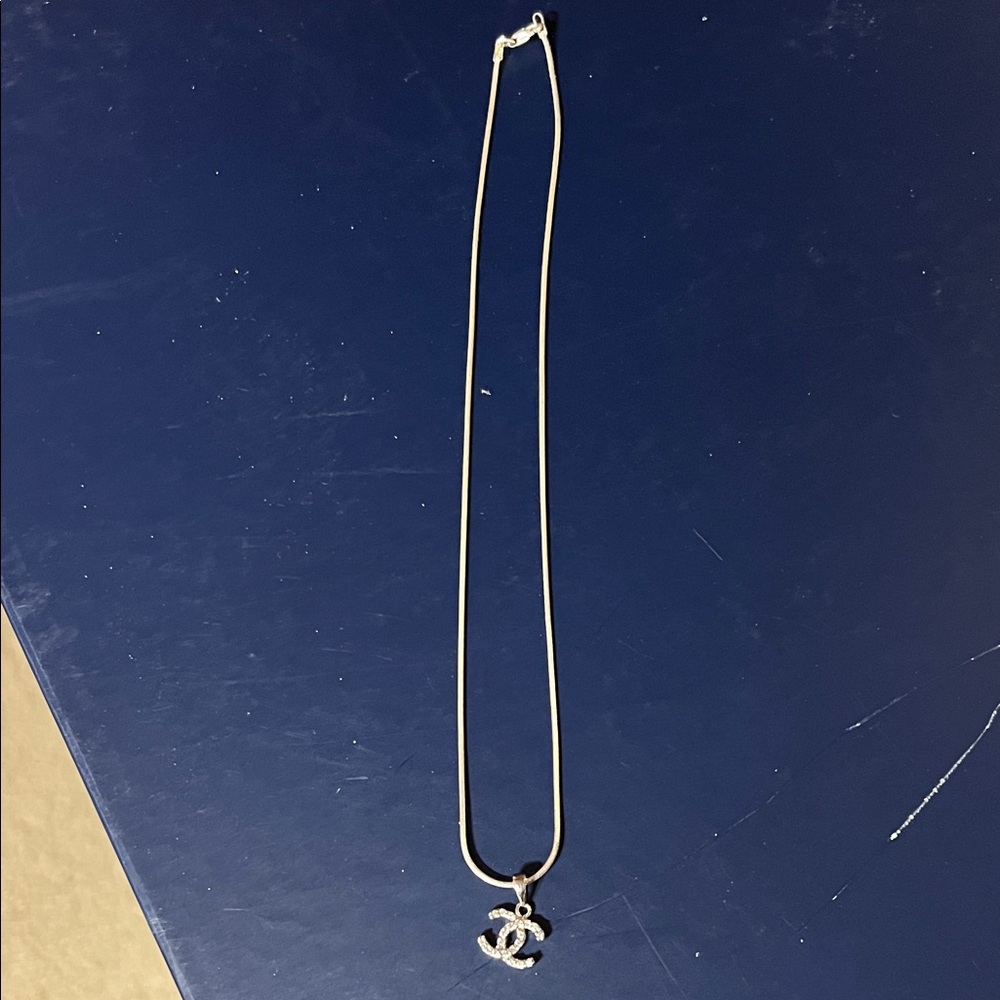 Elegant Silver Necklace with Iconic Pendant